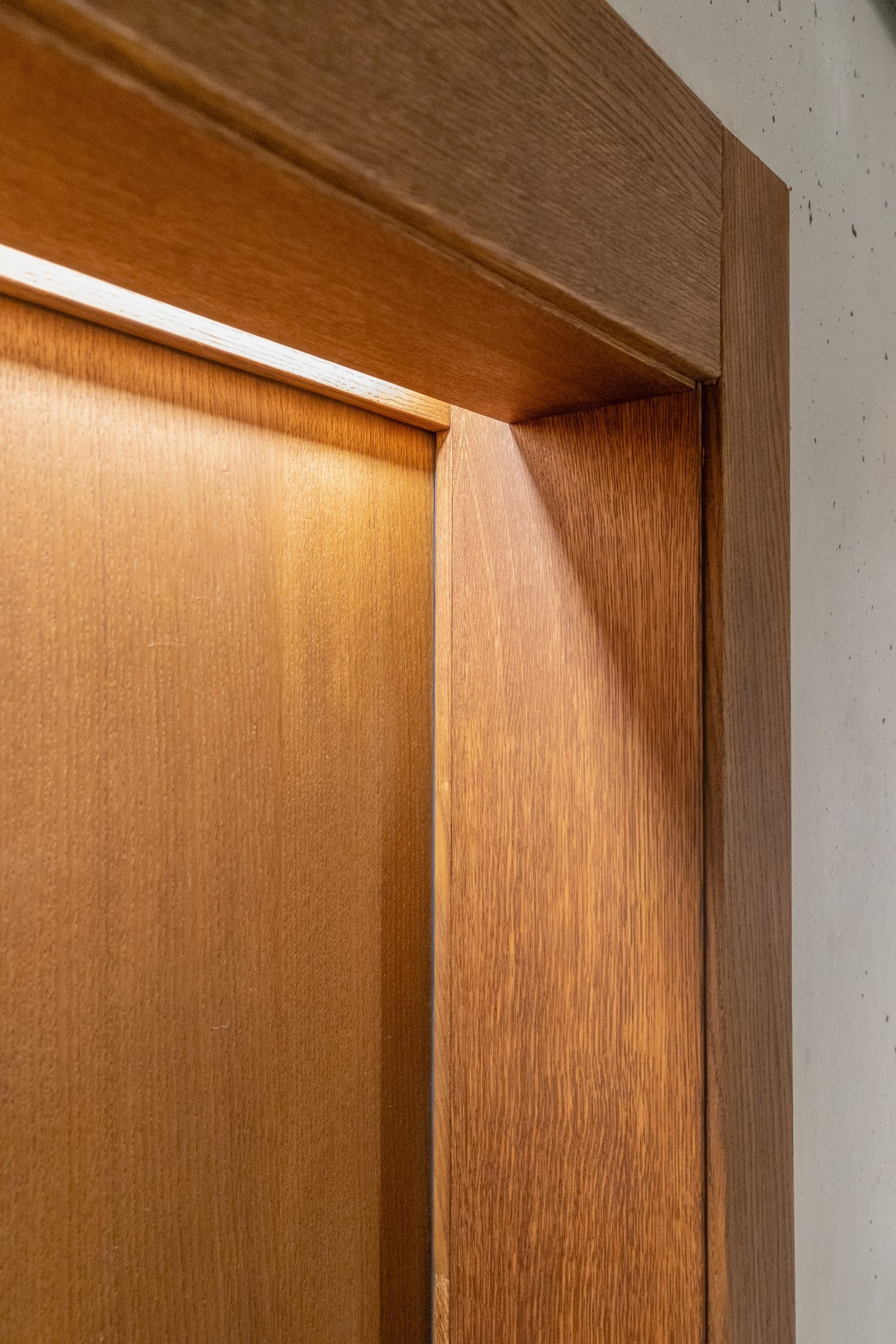 Detail of an oak door frame with concealed lighting